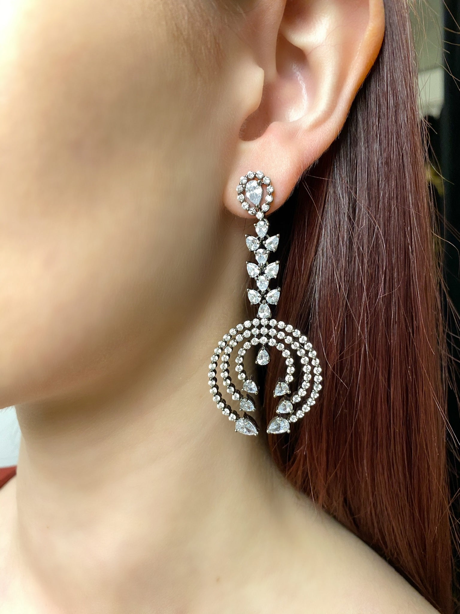 Three circle teardrop antique earrings on model