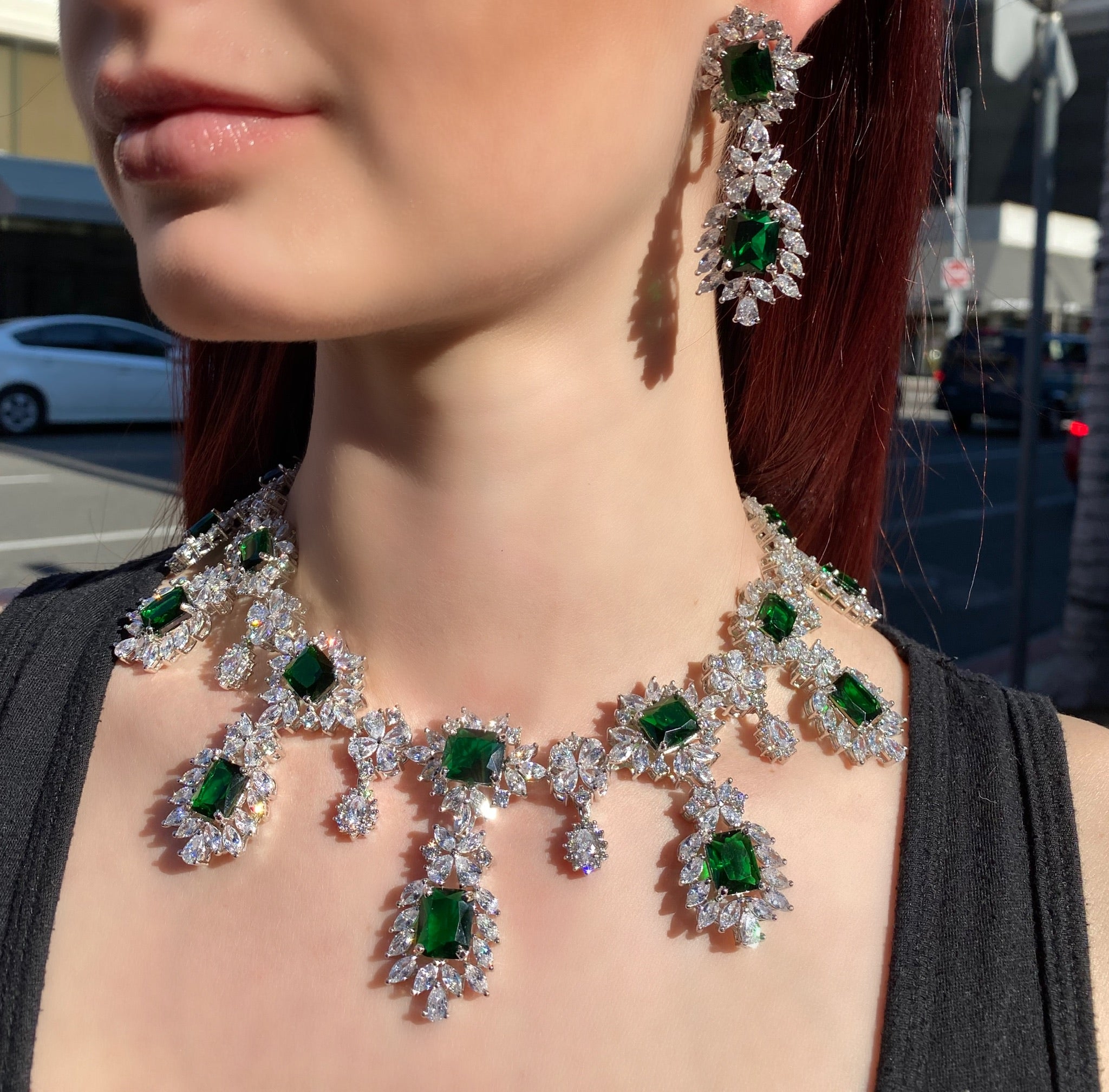 Emerald princess cut necklace and earrings on model