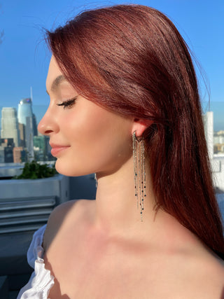 Floating shimmer chain earrings side view on model